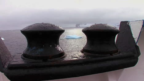 Artistic-shot-looking--through-tie-bars--to-see-ocean-below-with-icebergs-visible
