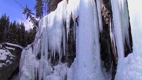 An-extreme-wide-shot-of-a-man-climbing-a-frozen-waterfall-1