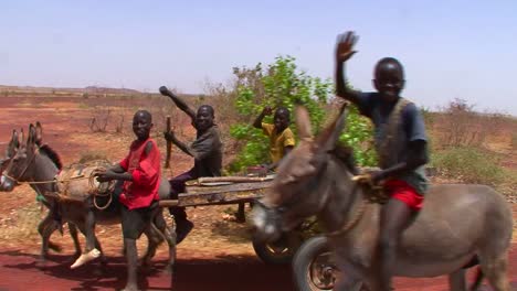 Boys-lead-a-donkey-cart-along-a-road-in-Mali-Africa