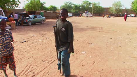 A-boy-walks-on-crutches-in-a-poor-African-town