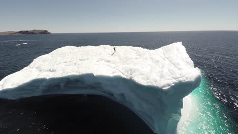 Eine-Erstaunliche-Antenne-über-Einem-Mann,-Der-Auf-Einem-Riesigen-Eisberg-In-Neufundland-Kanada-Steht