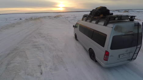 Vista-Aérea-as-a-truck-drives-across-frozen-tundra-in-the-Russian-Arctic-in-Siberia