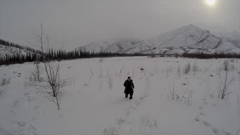 A-man-is-lost-and-runs-through-a-snowy-landscape-in-the-arctic