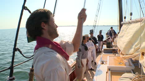 A-man-climbs-the-mast-of-a-19th-century-tall-ship-in-this-historical-reenactment