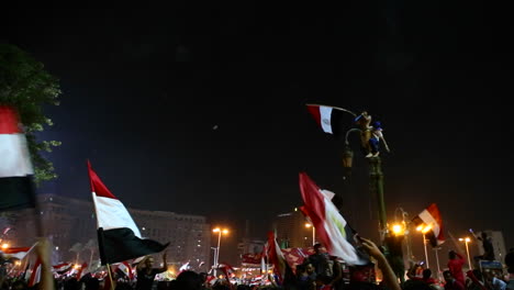 Protestors-wave-flags-and-fireworks-go-off-at-a-nighttime-rally-in-Cairo-Egypt-1