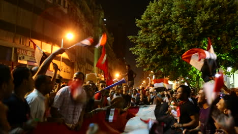 Protestors-wave-flags-and-fireworks-go-off-at-a-nighttime-rally-in-Cairo-Egypt-2