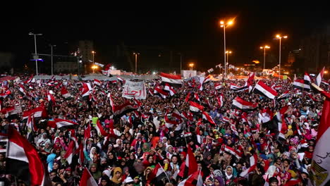 Protestors-wave-flags-and-fireworks-go-off-at-a-nighttime-rally-in-Cairo-Egypt-3