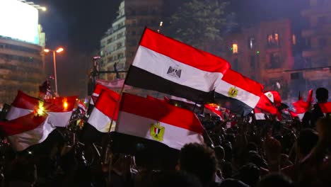 Protestors-wave-the-Egyptian-flag-in-Cairo-Egypt-at-a-large-nighttime-rally