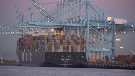 Blur-In-Shot-As-Goods-Are-Stacked-In-A-Container-Ship-At-Los-Angeles-Harbor