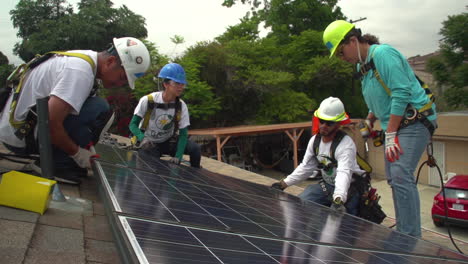 Workers-Install-Solar-Panels-On-The-Roof-Of-A-Middle-Class-House-4