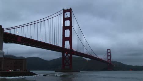 Surf-Rolls-Over-Rocks-Under-Historic-Golden-Gate-Bridge-In-San-Francisco-Bay