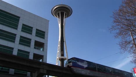A-Closeup-Of-The-Monorail-Passing-By-Seattle'S-Landmark-Space-Needle