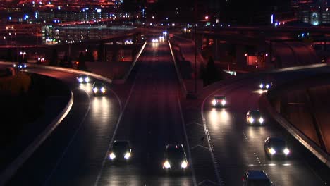 Vehicles-Enter-A-Freeway-In-Rush-Hour-At-Night