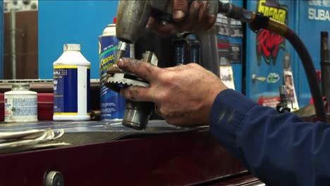 Closeup-Of-A-Mechanic-Removing-Bolts-From-A-Part-With-A-Powertool