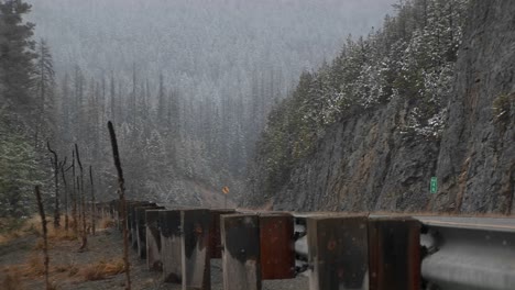 A-Scenic-Look-At-Mountain-Snow-Storm-From-The-Roadside-Safety-Barrier