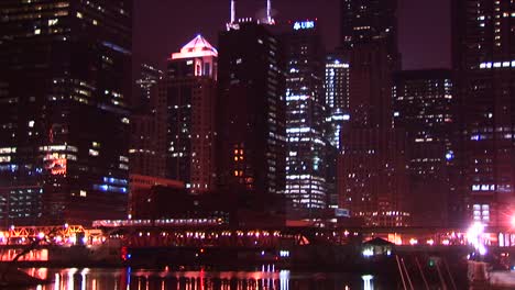 Chicago'S-Buildings-Sparkle-At-Night-As-A-Commuter-Train-Moves-Across-The-City