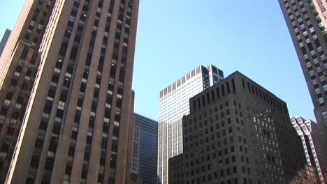 Camera-Pans-Up-From-The-Iceskating-Rink-For-A-Wormseye-View-Of-Surrounding-Skyscrapers
