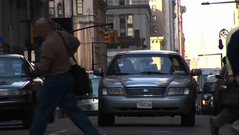 An-Eyelevel-Look-At-Traffic-And-Pedestrians-At-An-Urban-Intersection