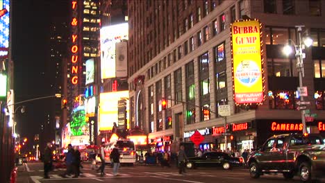 A-Busy-Downtown-Street-With-Lights-Pedestrians-And-Traffic-After-Dark