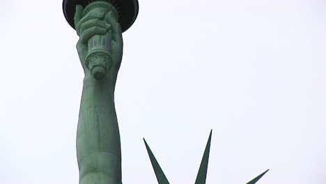 The-Camera-Pans-From-The-Head-And-Crown-Of-The-Statue-Of-Liberty-Up-To-The-Torch