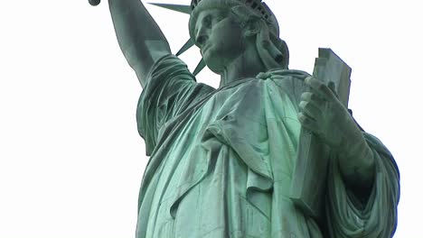 Wormseye-View-Of-The-Top-Half-Of-The-Refurbished-Statue-Of-Liberty-With-The-Tablet-She-Holds-In-One-Hand-And-The-Torch-In-The-Other-Clearly-Visible