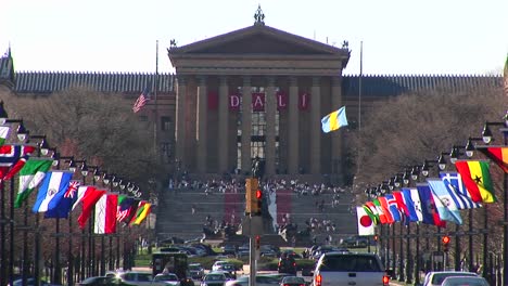 The-Camera-Pans-Up-From-The-Traffic-And-Flags-On-Benjamin-Franklin-Parkway-To-The-Philadelphia-Museum-Of-Art-And-Its-Famous-Steps