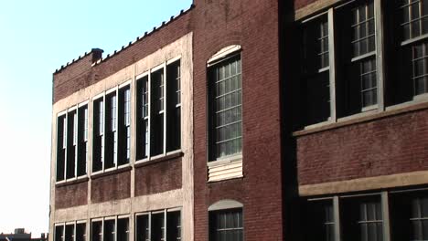 The-Camera-Zooms-In-On-Old-Red-Brick-Innercity-School-Building-With-Dingy-Windows