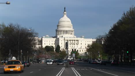 Traffic-Flows-In-Many-Directions-On-The-Treelined-Streets-In-Front-Of-The-United-States-Capitol-Building