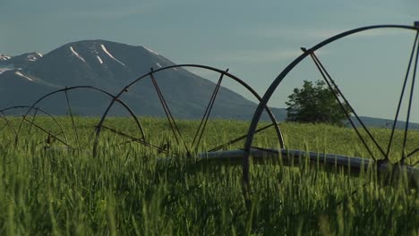 Medium-Shot-Of-Irrigation-Sprinklers-On-Utah-Farmland-And-The-La-Sal-Mountains-In-The-Background