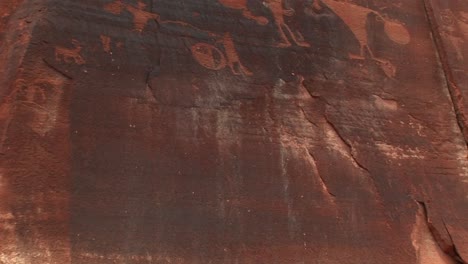 Pan-Up-Shot-Of-Ancient-Petroglyphs-On-A-Sandstone-Cliff