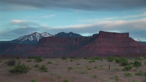 Medium-Shot-Of-Castle-Rock-Standing-In-Front-Of-The-La-Sals-Mountains-In-Utah