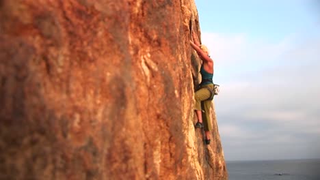 Panright-Of-A-Rock-Climber-Attempting-To-Climb-A-Cliff-Wall-Over-The-Pacific-Ocean