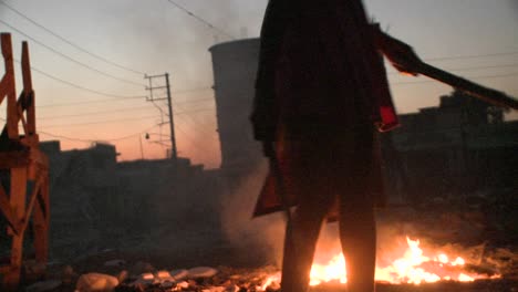 Children-stand-in-front-of-a-fire-in-a-third-world-country