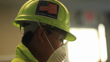 An-American-factory-worker-wears-a-helmet-with-a-flag