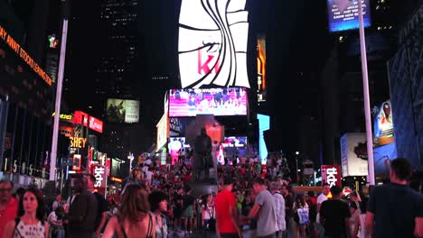 Kippen-Sie-Die-Aufnahme-Von-Times-Square,-Die-Nachts-Beleuchtet-Und-überfüllt-Sind-1