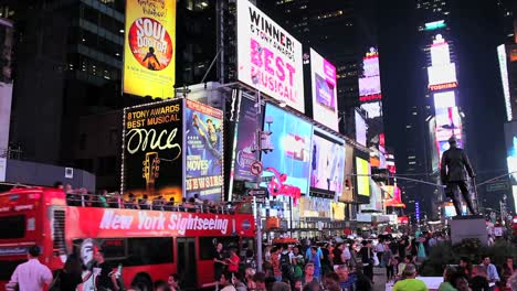 Times-Square-Iluminado-Y-Lleno-De-Gente-Por-La-Noche
