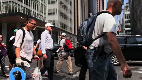 Pedestrians-pass-on-a-busy-street-in-New-York-City