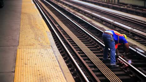 A-worker-works-on-the-tracks-at-a-train-station-in-New-York-City