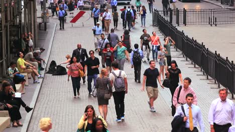 High-angle-shot-of-pedestrians-walking-along-Wall-Street-in-New-York-City