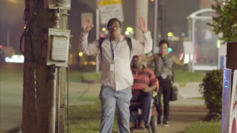 Citizens-walk-on-the-sidewalk-with-hands-raised-as-police-try-to-manage-the-rioting-in-Ferguson-Missouri