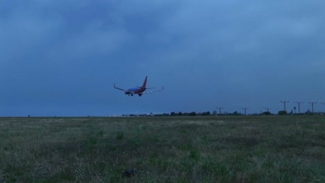 A-jet-avión-lands-on-an-airport-runway-against-darkened-skies