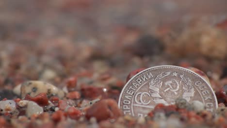 Coin-in-the-Wet-Sand