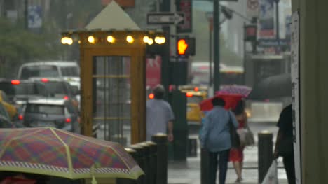 People-Walking-Through-Rain-Under-Umbrellas