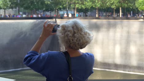 Lady-Photographing-the-911-Memorial-New-York