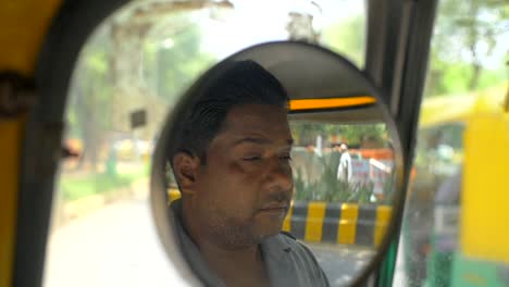 Handheld-Shot-of-a-Tuk-Tuk-Driver-in-Wing-Mirror