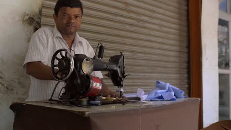 Reveal-Shot-of-a-Man-Ironing-Cuts-of-Fabric