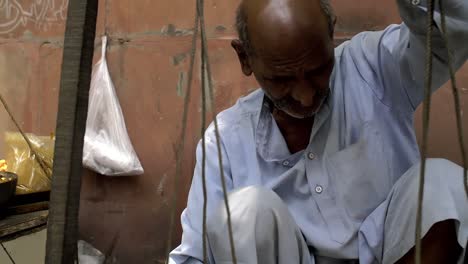 Elderly-Man-Fills-and-Weighs-a-Bag-of-Chickpeas