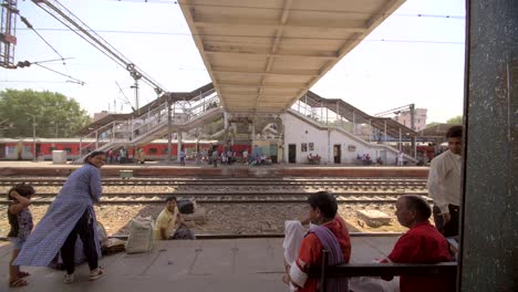 Hombre-indio-lleva-bolsas-a-través-de-una-vía-de-tren