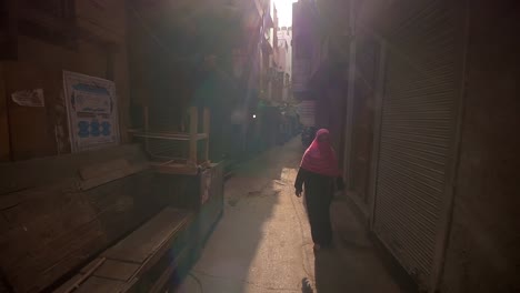 Woman-in-a-Hijab-Walks-Down-a-Narrow-Alley