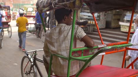 Handheld-Shot-of-a-Driver-Sitting-in-a-Rickshaw